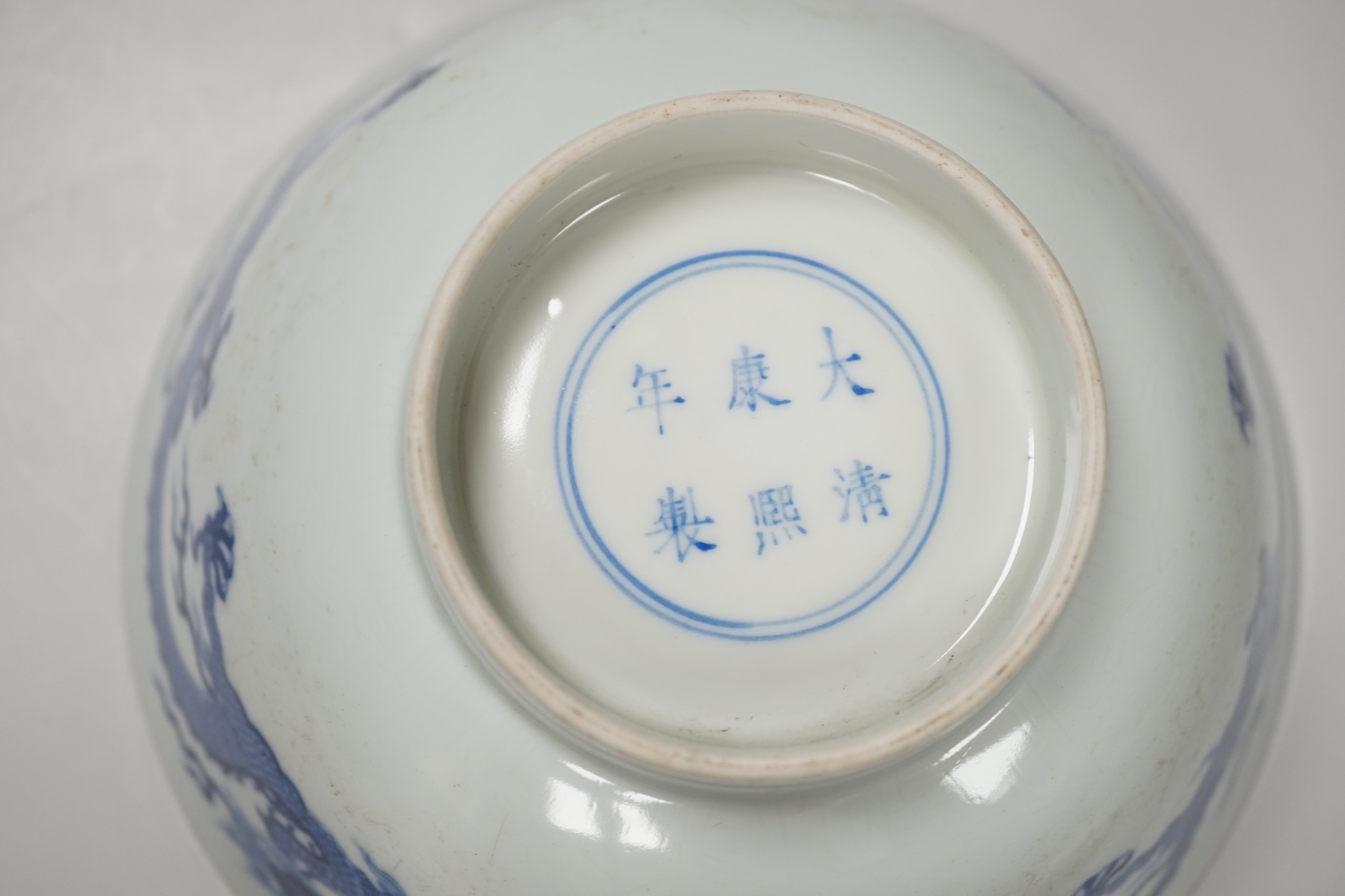 A Chinese blue and white bowl, hand painted with dragons, housed in a fitted case, 18cm in diameter